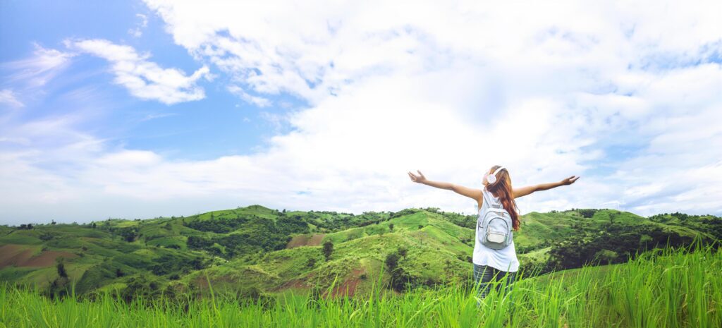 Asian women travel relax in the holiday. on a green pasture. Stock Free