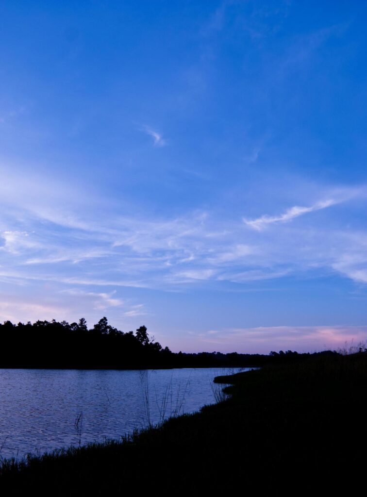 Beautiful sky landscape with sunset over river bank Stock Free