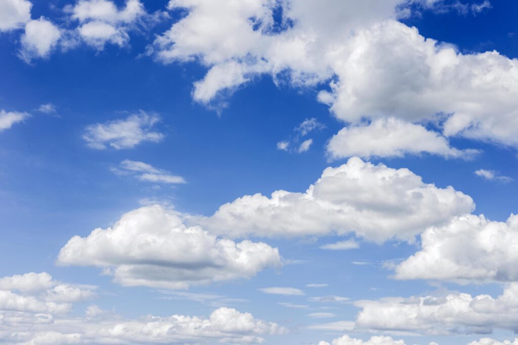 clear blue sky with plain white cloud with space for text background. The vast blue sky and clouds. blue sky background with tiny clouds nature. Stock Free