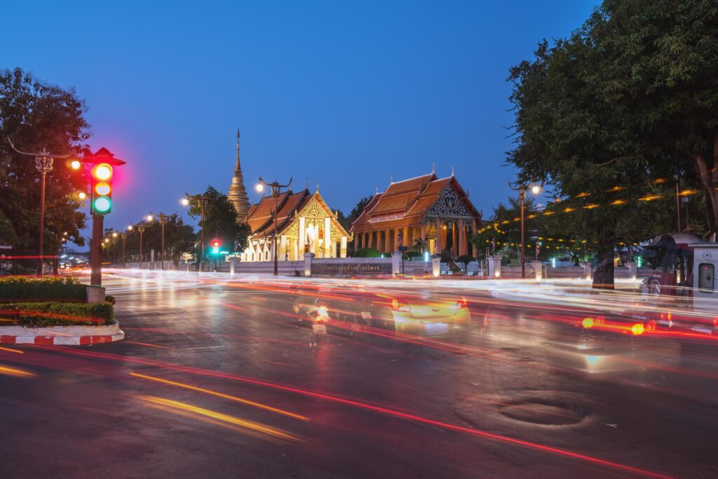 Buddhist temple of Wat Pra Tard Chang Kum in Nan, Thailand with trafic jam at night scene. Stock Free