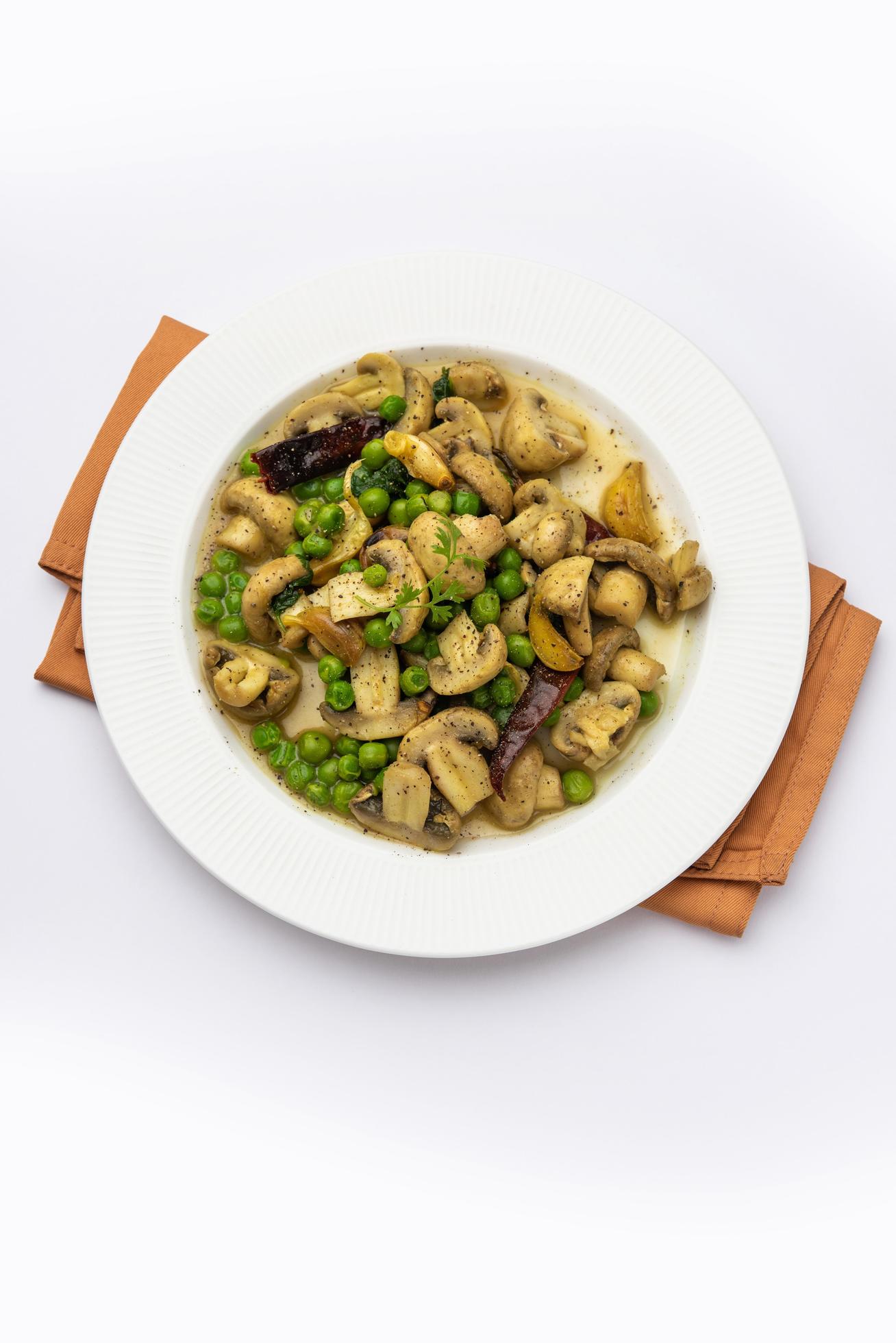 Mushroom and Pea Curry with Roasted Garlic, Indian food served in a bowl Stock Free