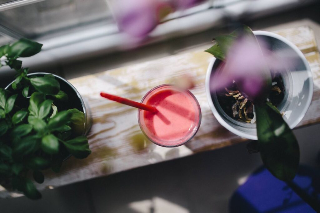 Fresh and healthy fruit milkshake with a straw Stock Free