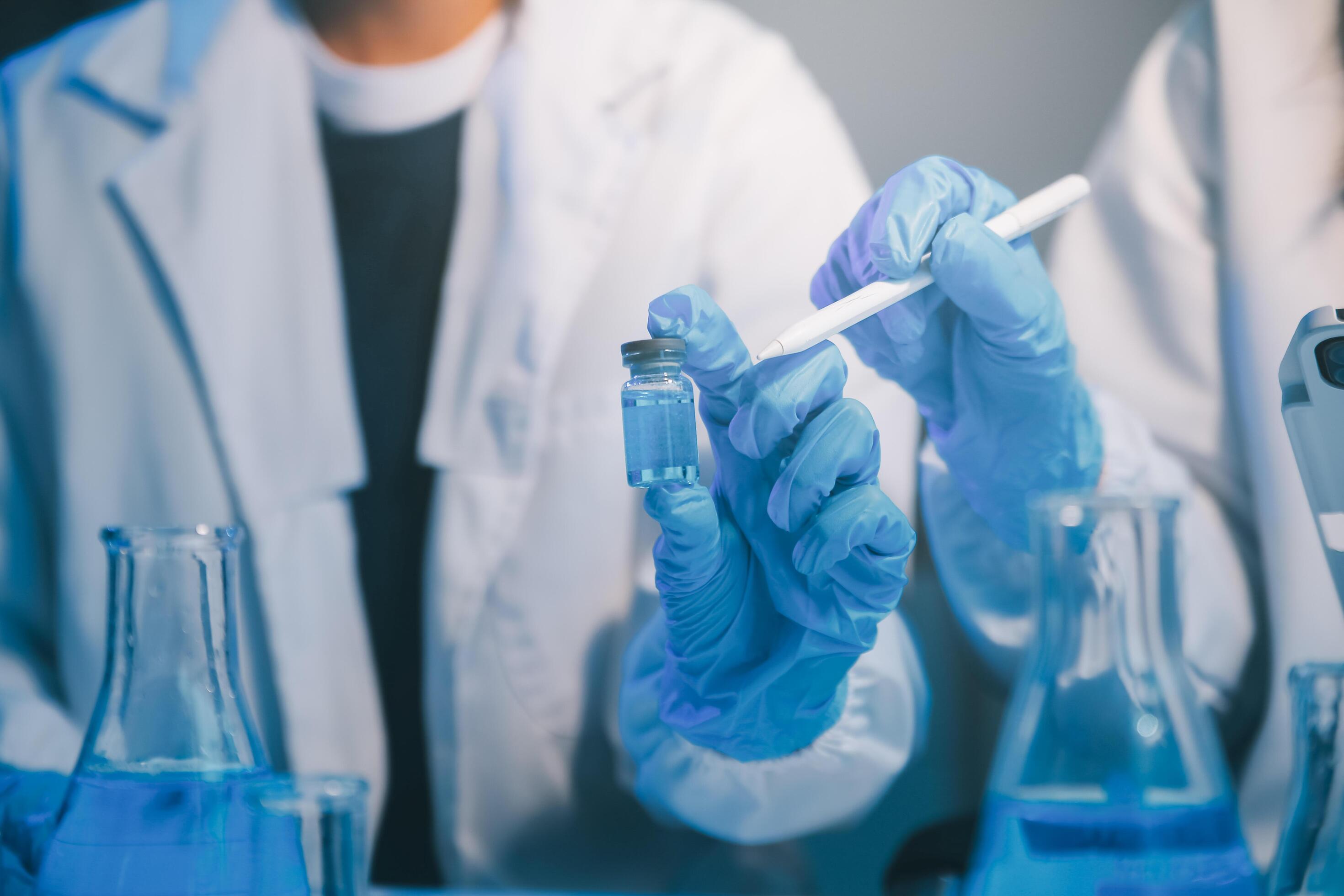 chemist,scientist hand dropping chemical liquid into test tube, science research and development concept Stock Free