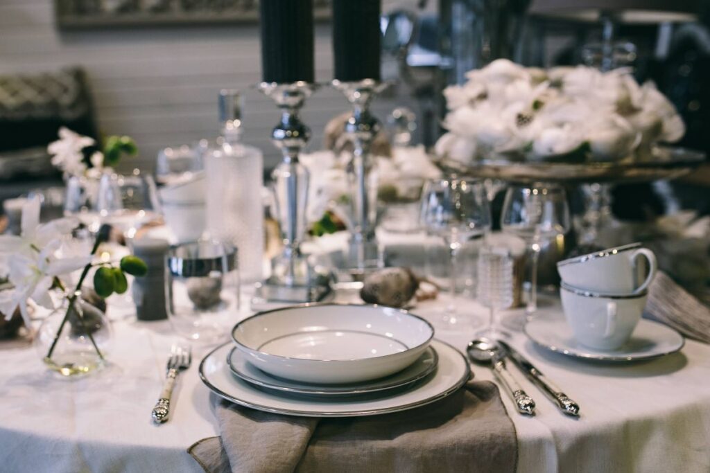 Fancy restaurant dinner table decorated with quail eggs and feathers Stock Free