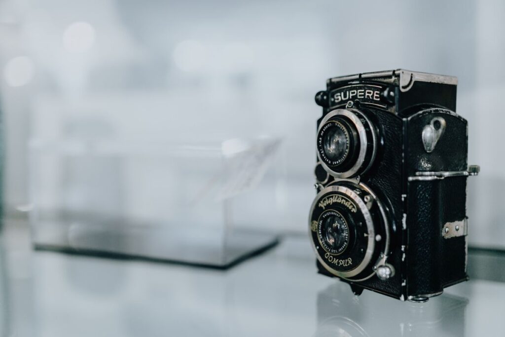 Old camera on glass shelf Stock Free