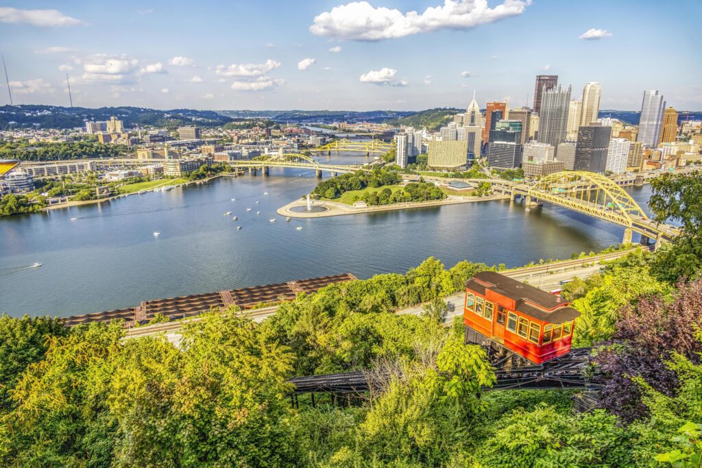 Red tram going down an incline in a city Stock Free