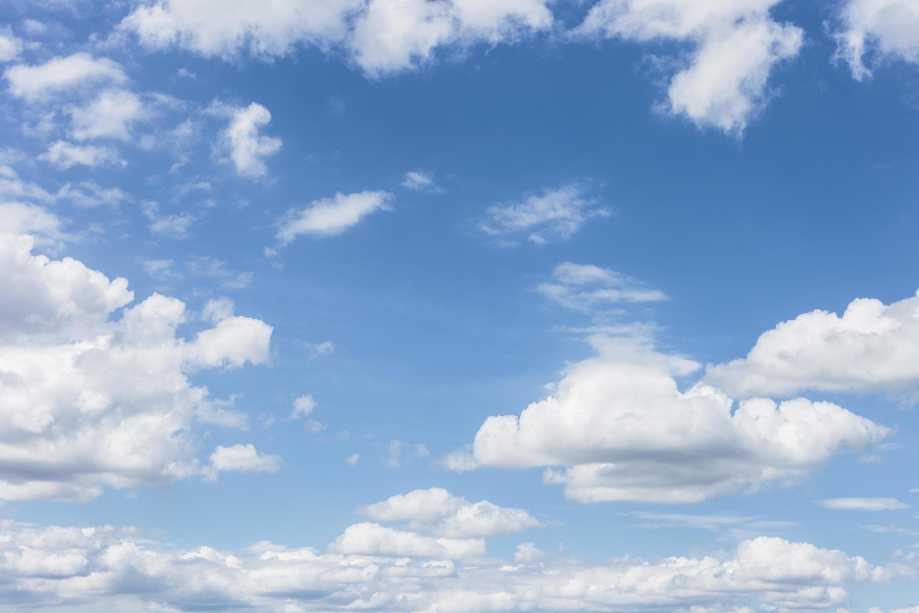 clear blue sky with plain white cloud with space for text background. The vast blue sky and clouds. blue sky background with tiny clouds nature. Stock Free