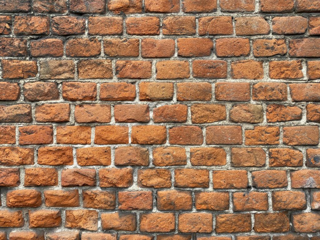 old terracotta brick wall background Stock Free