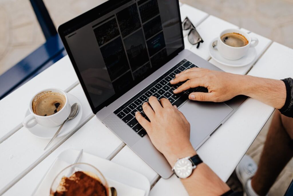 Working with a laptop by the sea. Cup of coffee and delicious tiramisu, Marina di Puolo, Italy Stock Free