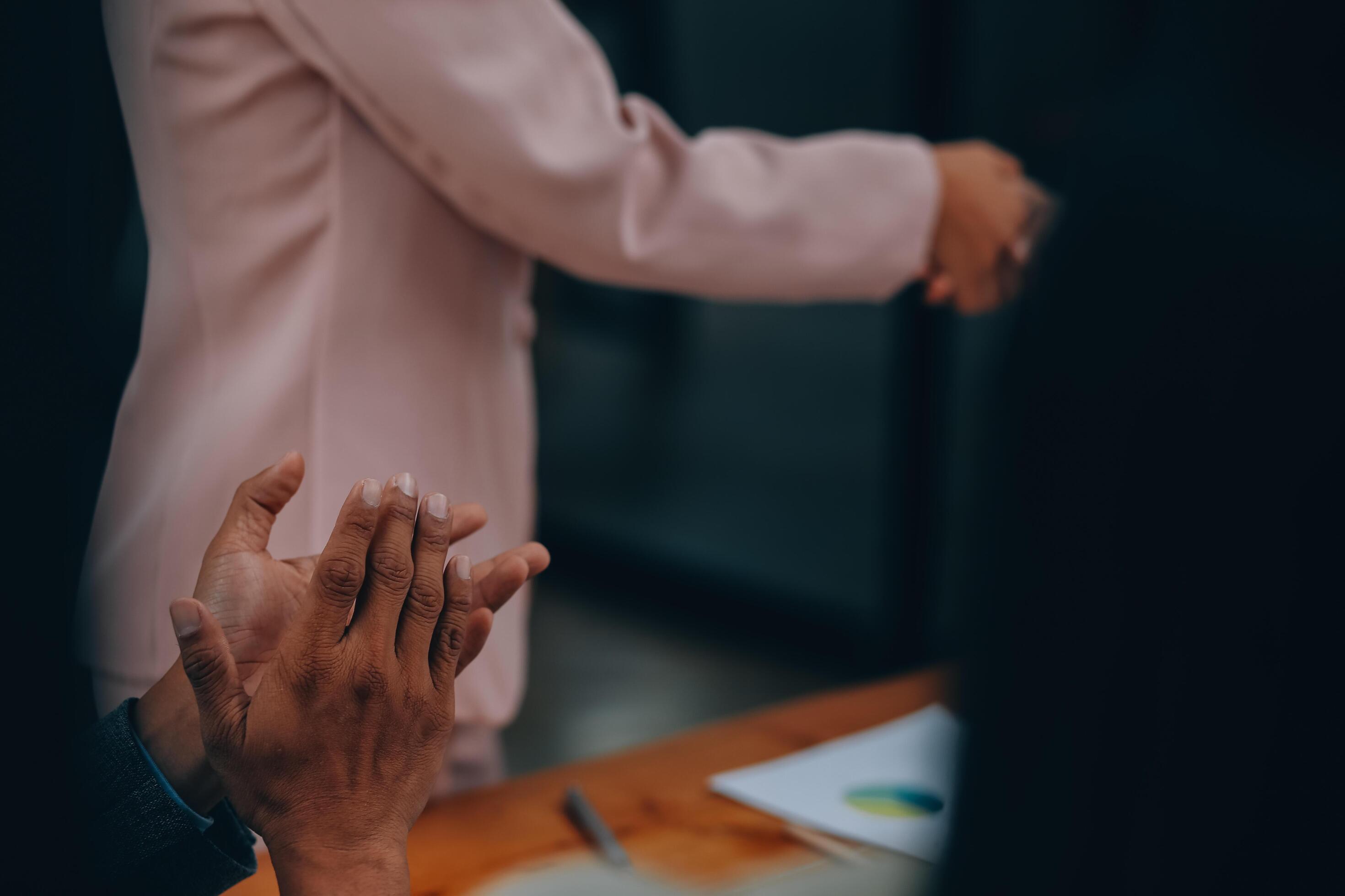 Businesswoman partnership handshake concept. Two young asian business professionals celebrating teamwork in an office, Colleague in meeting. Stock Free