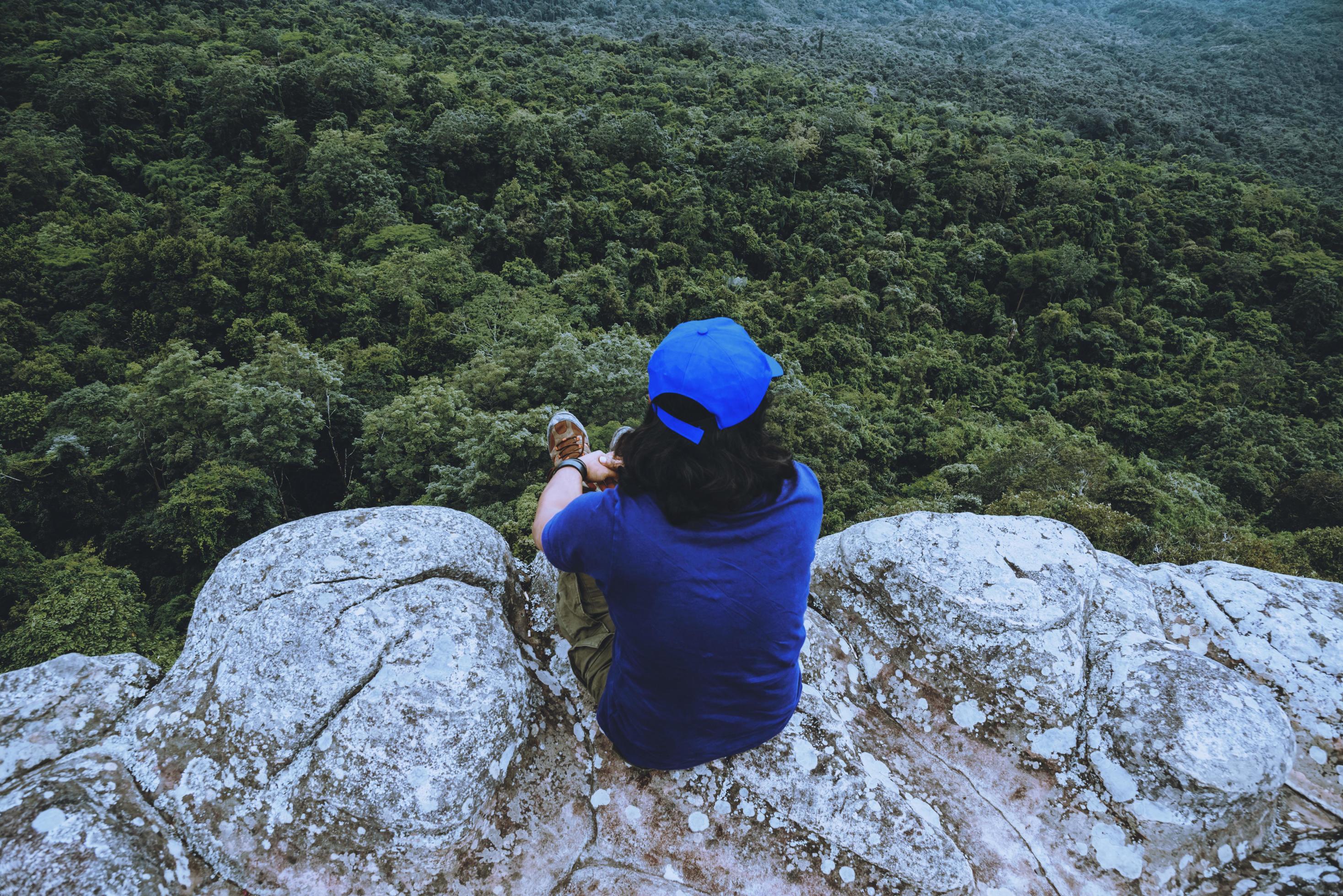 man asians travel relax in the holiday. View mountain nature on the cliffs. Stock Free