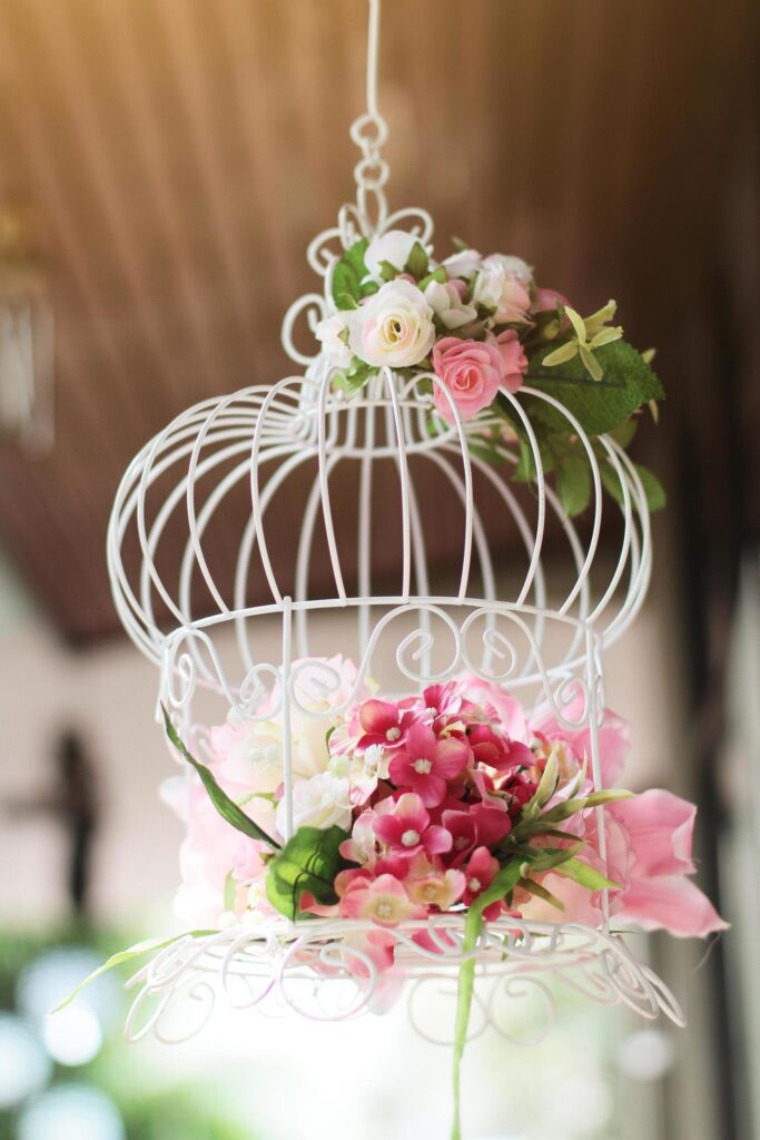 White birdcage decorated with roses flowers hanging decoration in wedding Stock Free