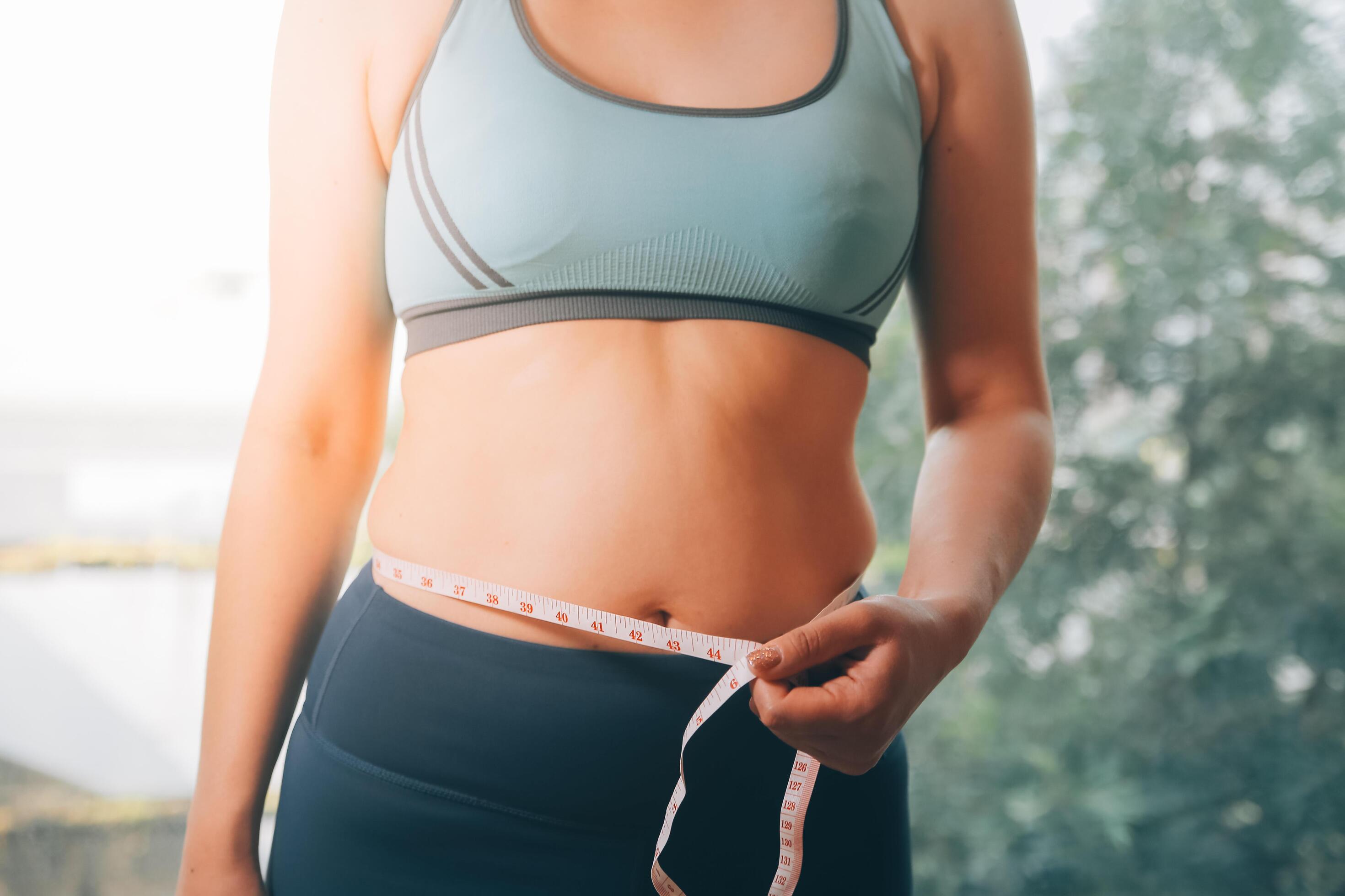 fat woman, fat belly, chubby, obese woman hand holding excessive belly fat with measure tape, woman diet lifestyle concept Stock Free