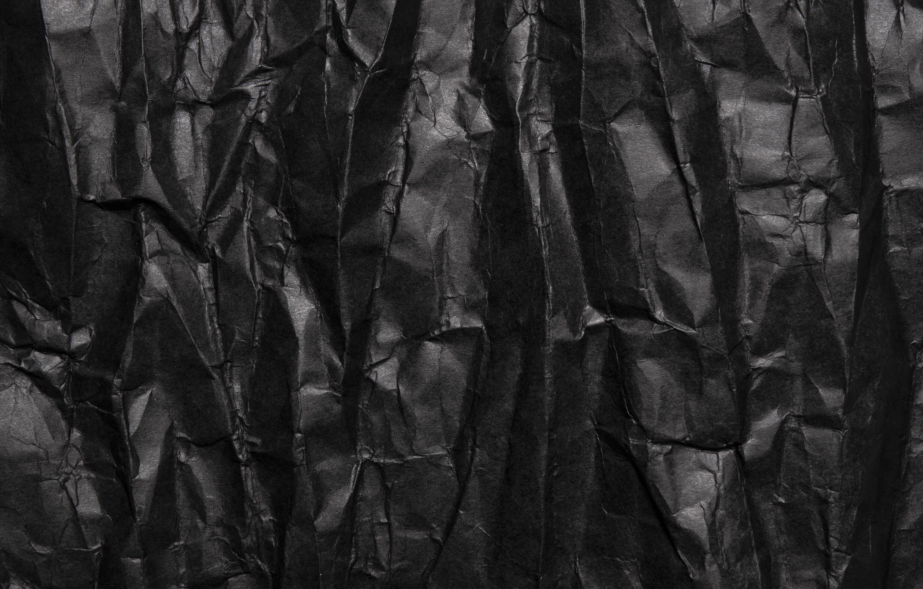 Black crumpled paper texture, grunge background Stock Free