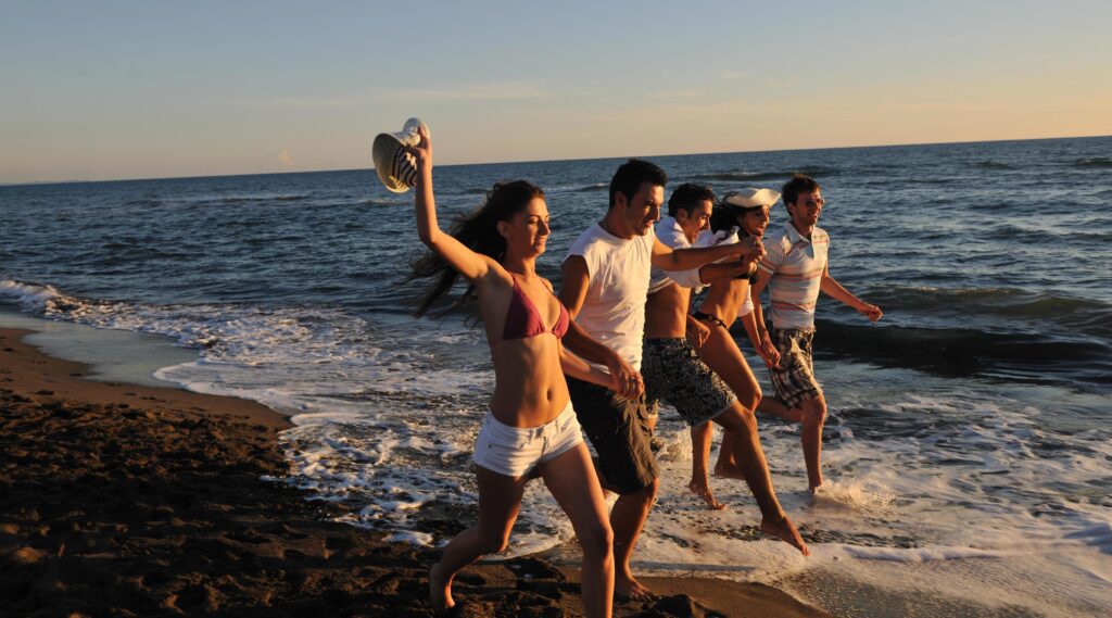 people group running on the beach Stock Free