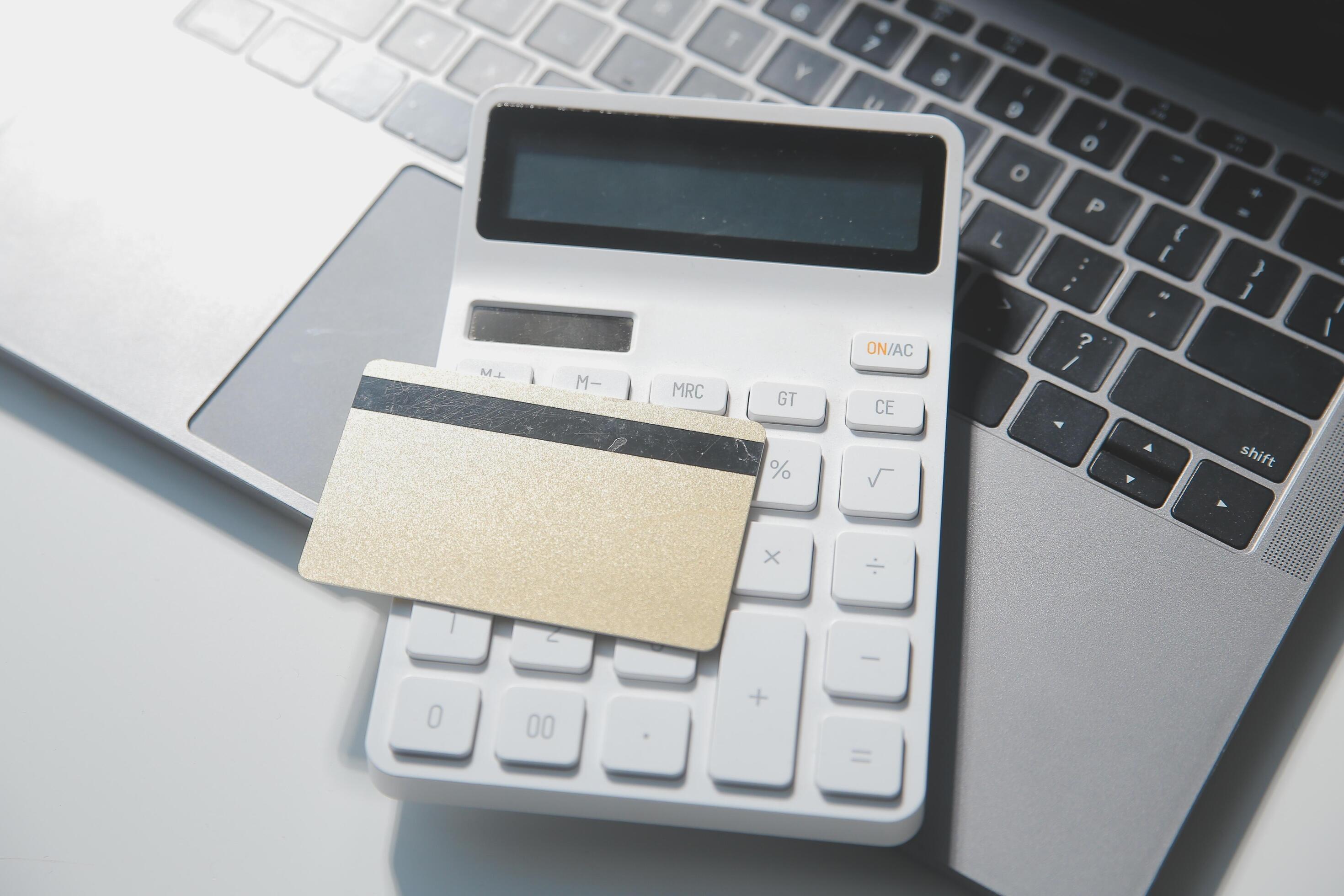 Calculator on a dark background, plastic cards and banknotes Stock Free