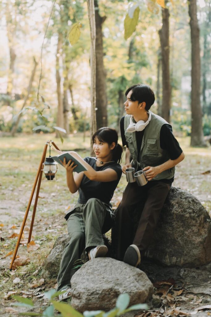 Asian couple sweet in tent inside on they camping trip, traveller relax and sleep togather in out door and camping trip Stock Free