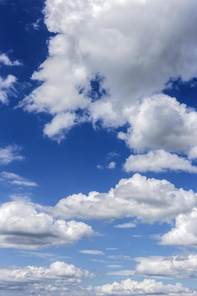 clear blue sky with plain white cloud with space for text background. The vast blue sky and clouds. blue sky background with tiny clouds nature. Stock Free