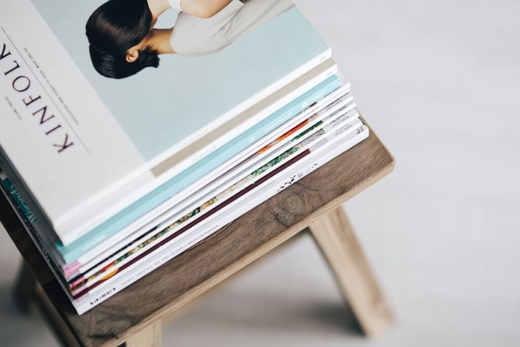 
									Stack of magazines on the wooden stool Stock Free