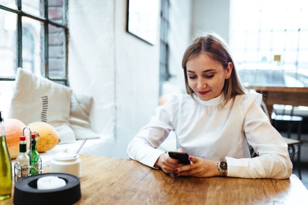 Pretty blonde woman sitting in the cafe Stock Free