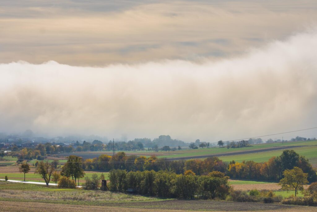 huge wall of white fog over a village in the nature landscape detail Stock Free