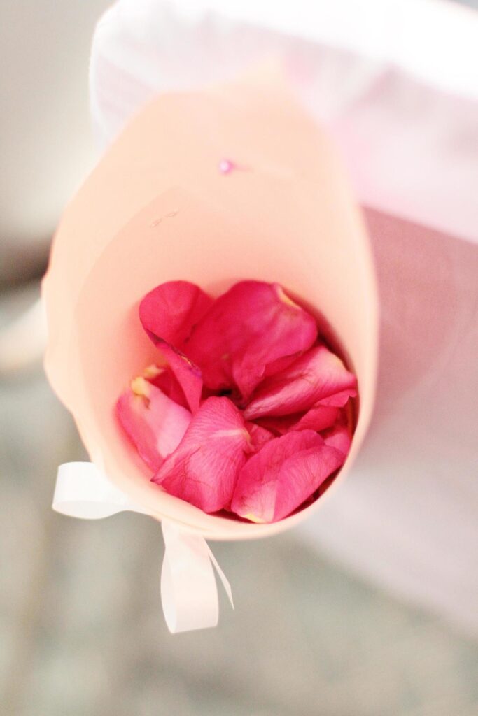 Beautiful Pink Rose petals Flowers decorated on white chair in wedding ceremony Stock Free