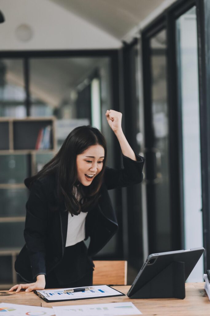 Asian business woman are delighted and happy with the work they do on their tablet, laptop and taking notes at the modern office. Stock Free