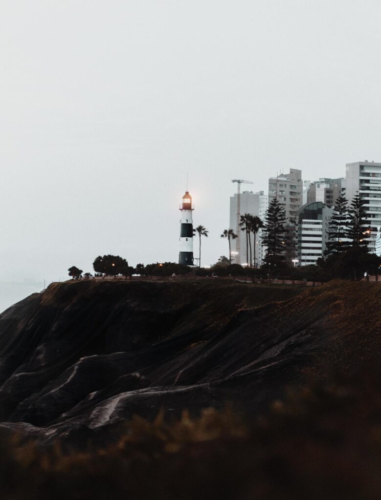 Illuminated lighthouse in the fog Stock Free