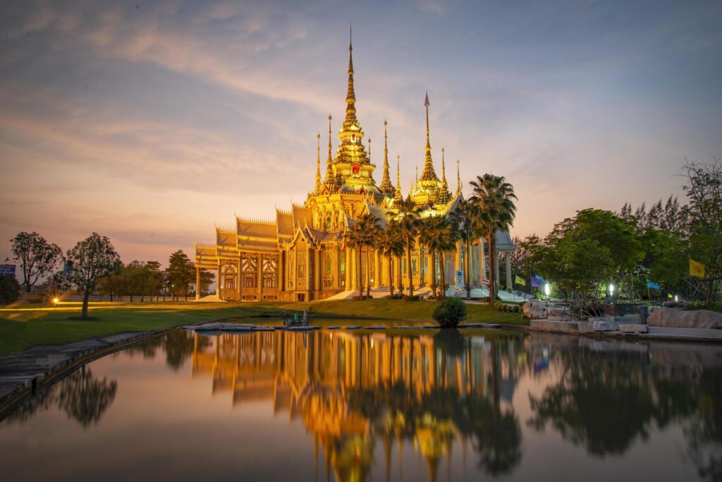 Beautiful temple thailand dramatic colorful sky twilight sunset shadow on water reflection Stock Free