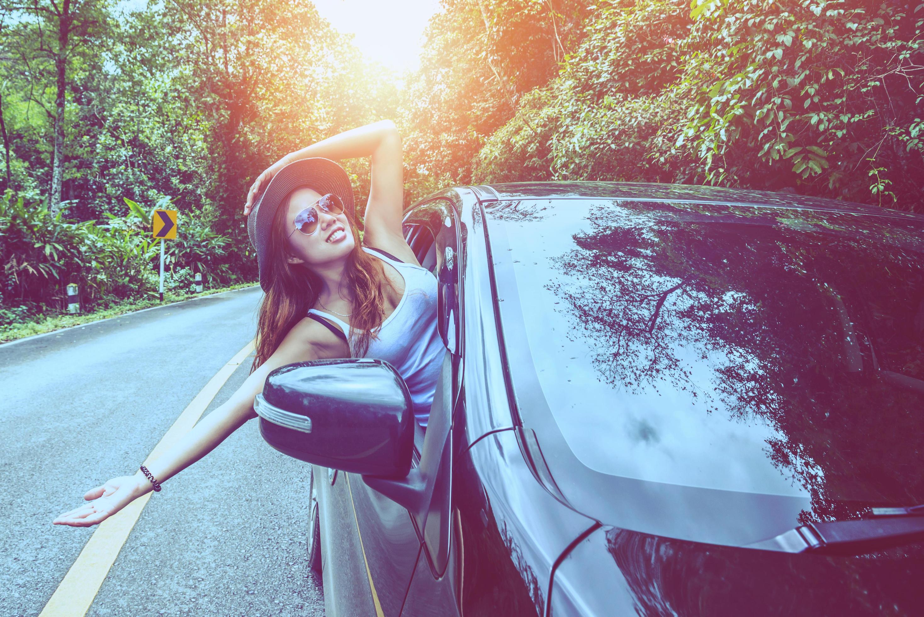 Asian women travel relax in the holiday. Traveling by car park. happily With nature, rural forest Stock Free