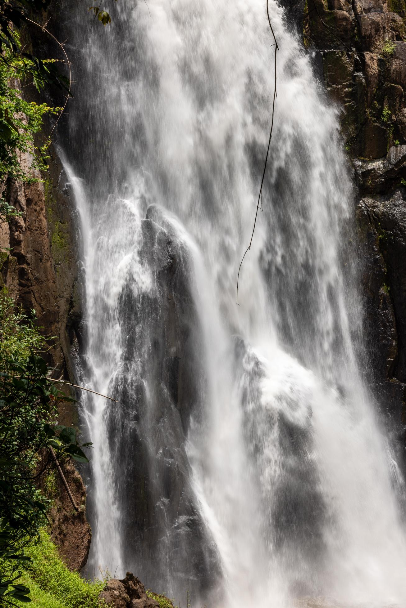 A natural waterfall in a big forest in the midst of beautiful nature. Stock Free