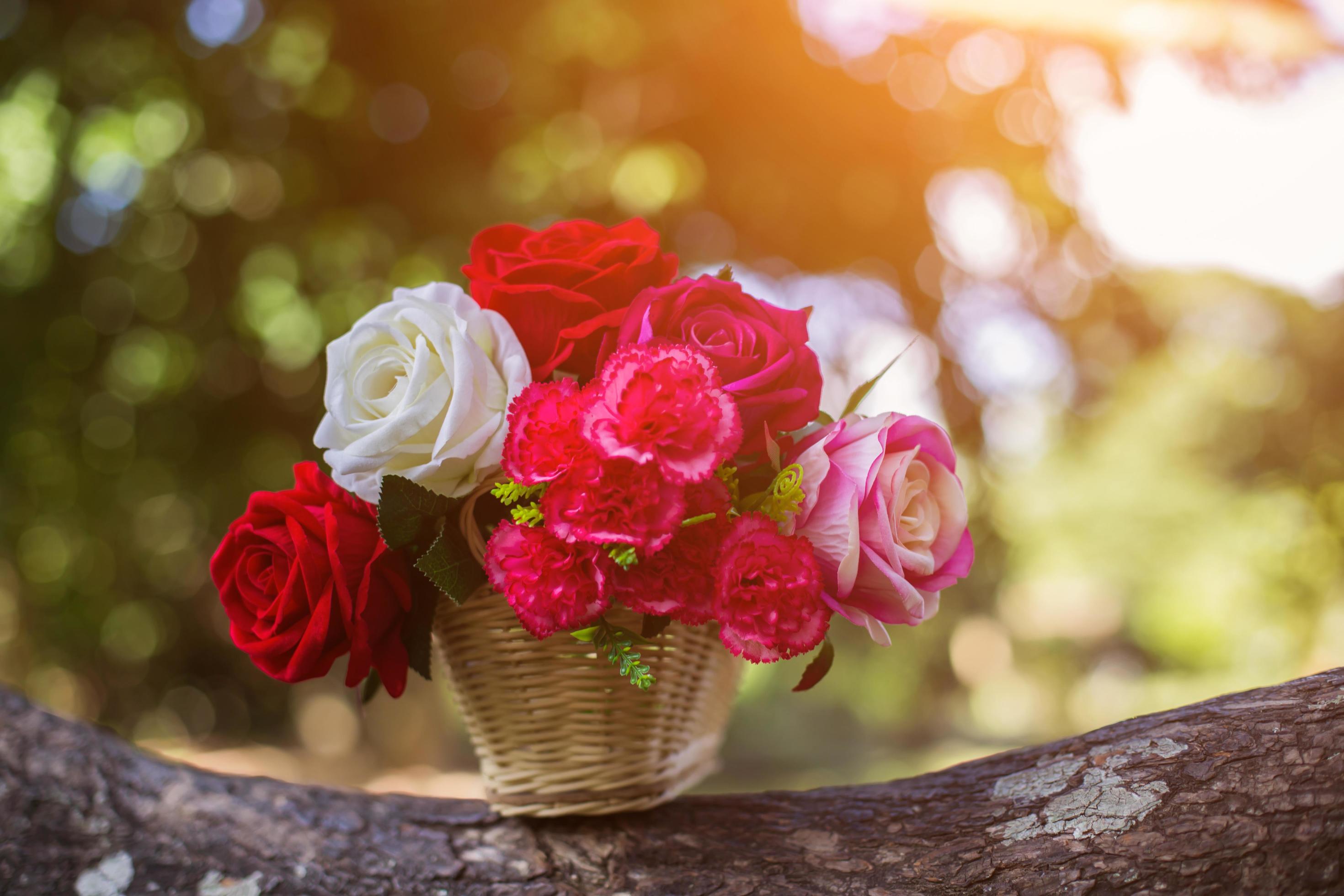 Mixed beautiful flowers in the vase on wooden background Stock Free