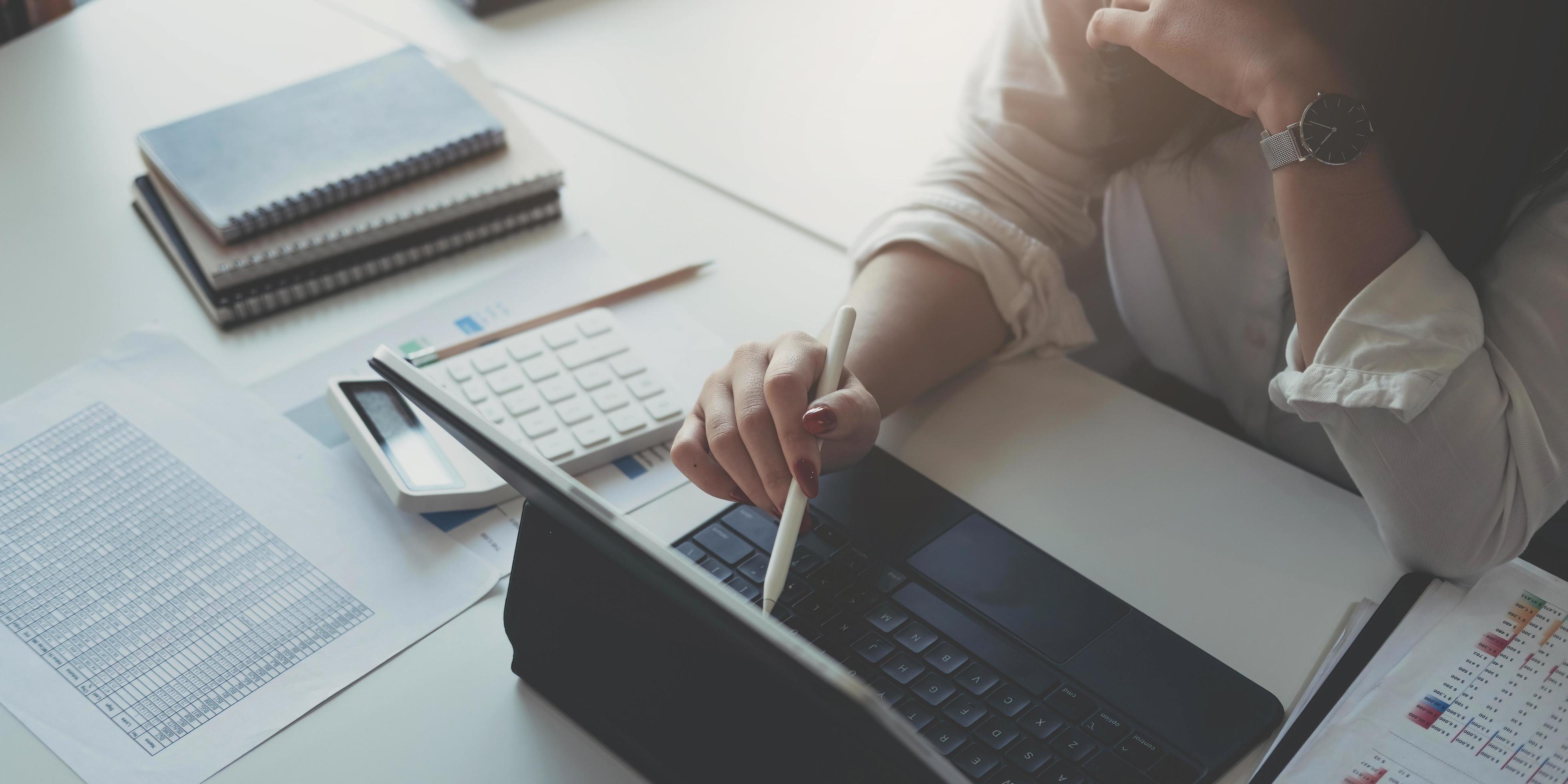 Businesswoman using laptop computer keyboard at the office. Stock Free