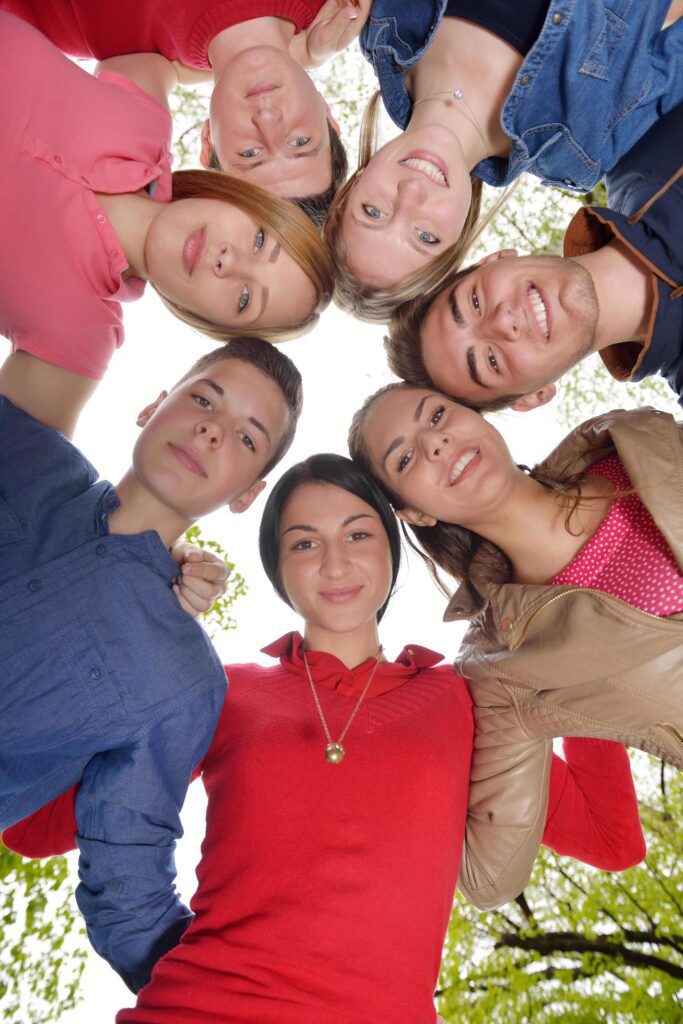 young friends staying together outdoor in the park Stock Free