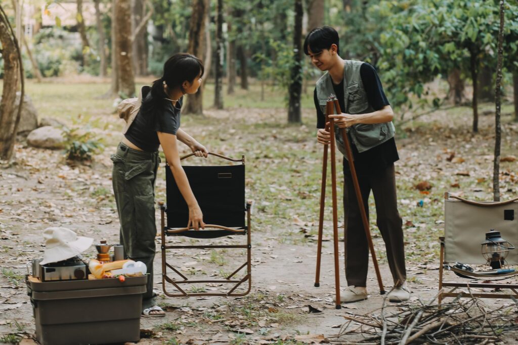 Asian couple sweet in tent inside on they camping trip, traveller relax and sleep togather in out door and camping trip Stock Free