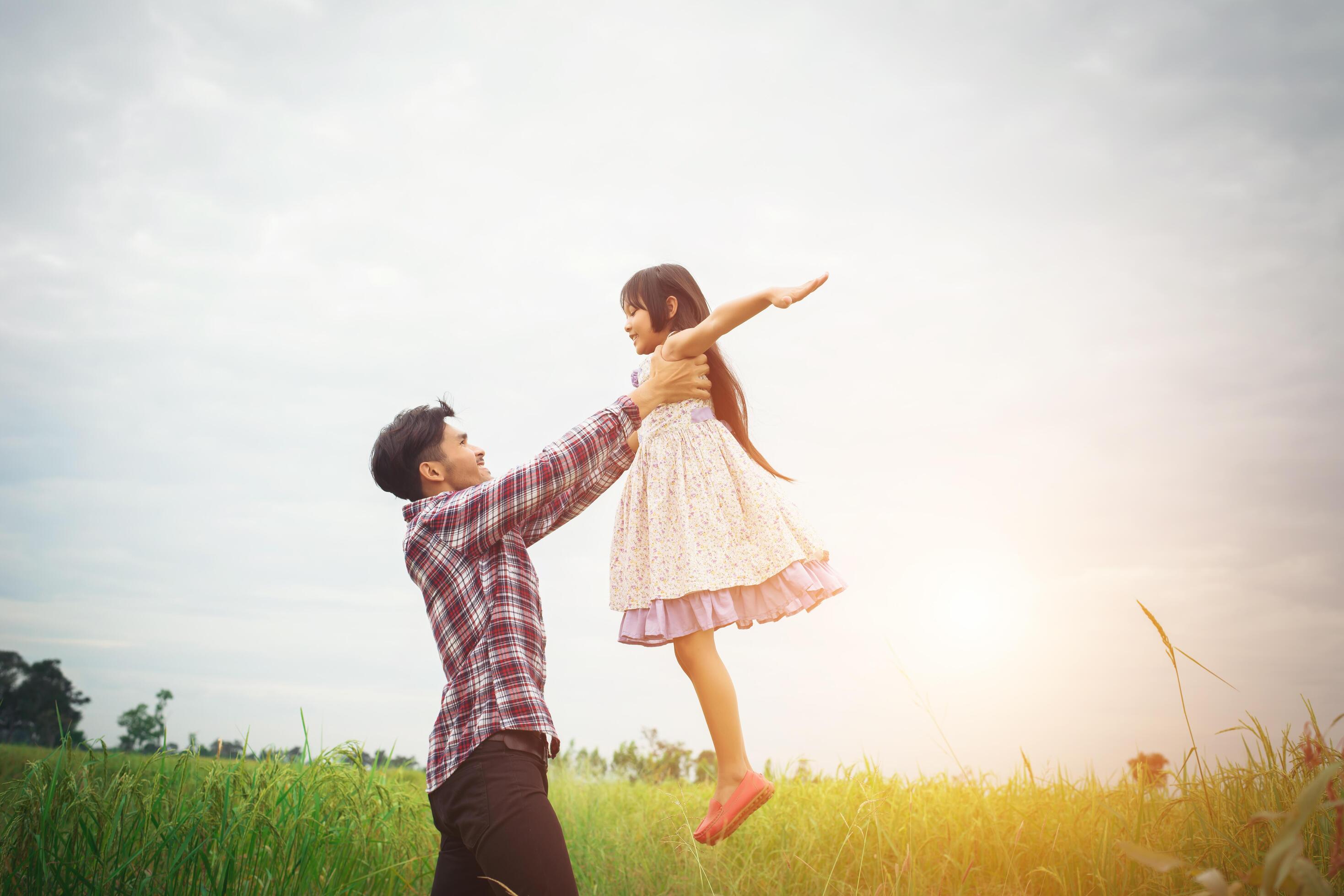 Daddy carrying his daughter with nature and sunlight, enjoyment family. Stock Free