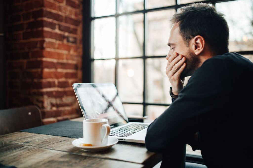 Young Entrepreneur Working from a Modern Cafe Stock Free