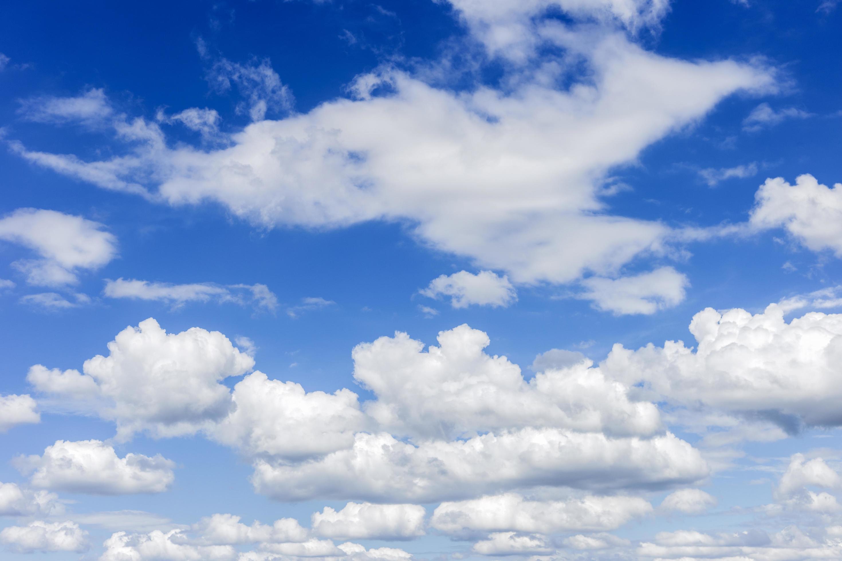 clear blue sky with plain white cloud with space for text background. The vast blue sky and clouds. blue sky background with tiny clouds nature. Stock Free