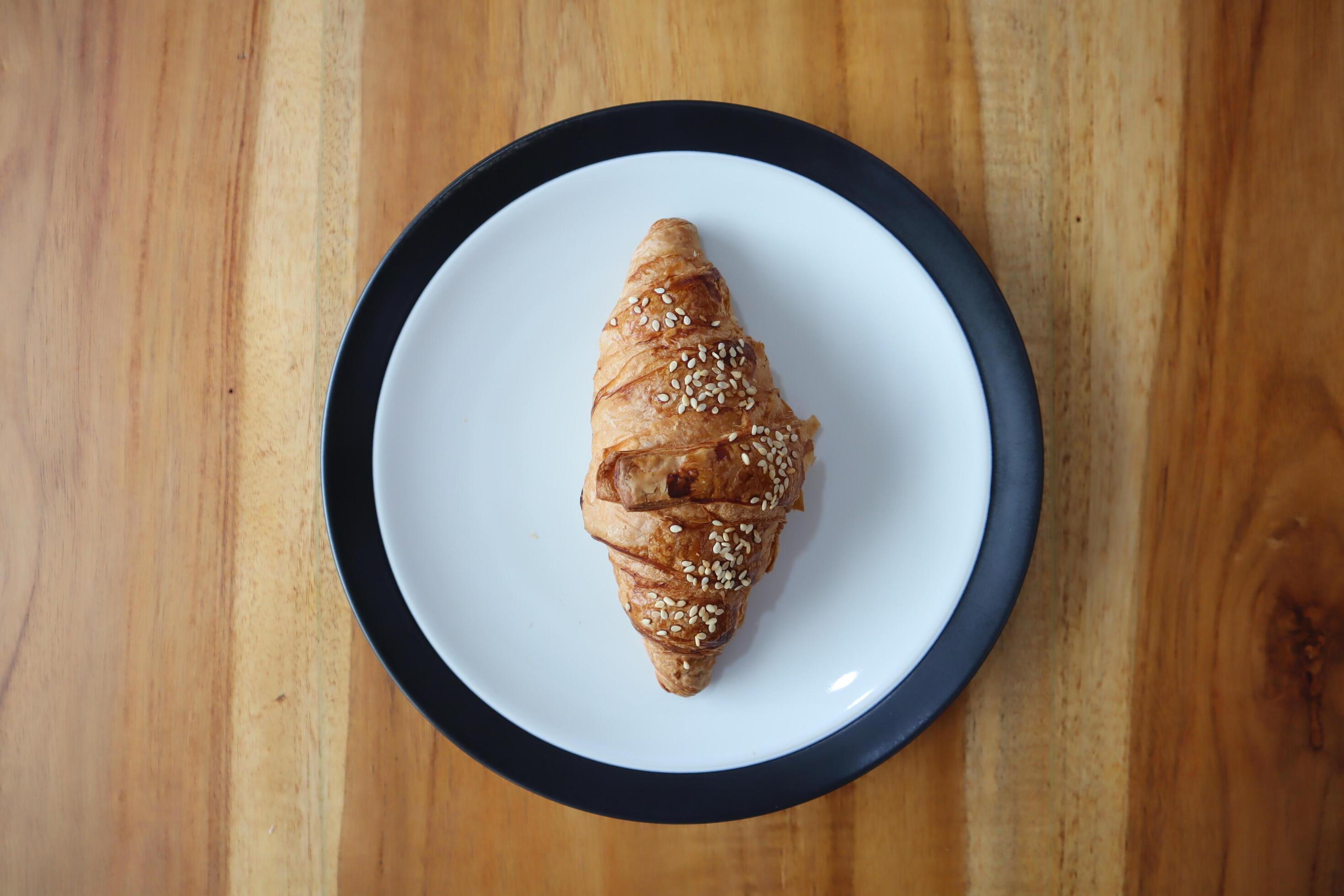 A plate of smoked beef croissants on the table background Stock Free