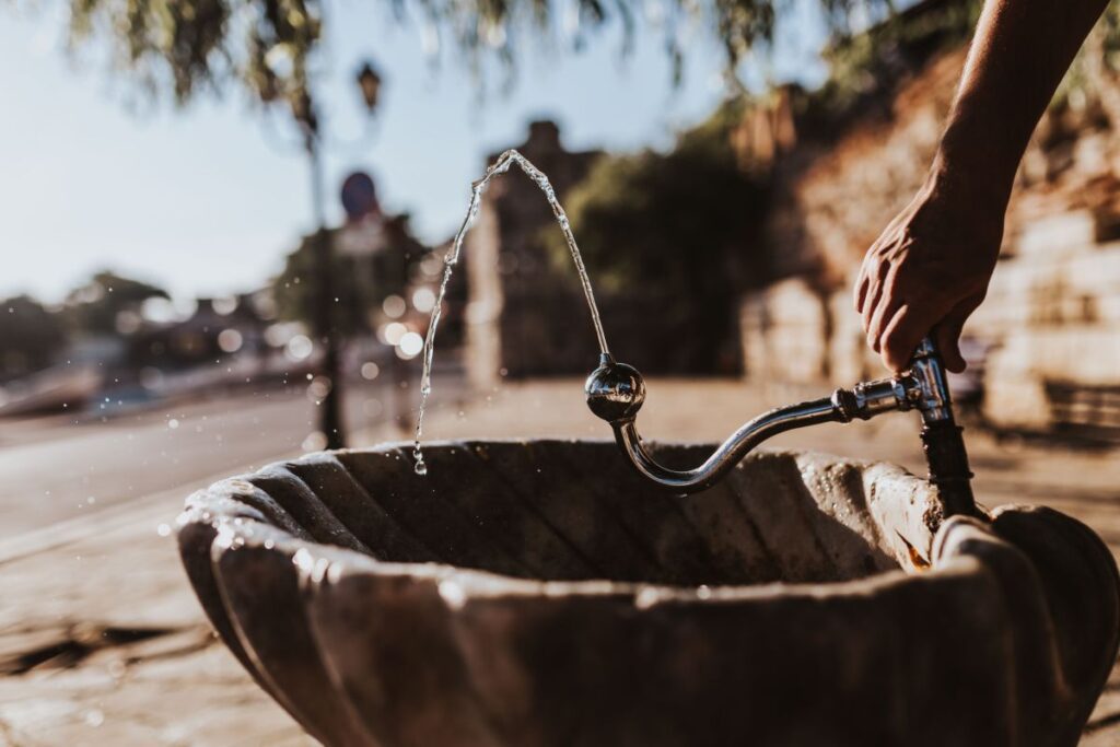 Drinking fountain with stream of water on the sidewalk Stock Free