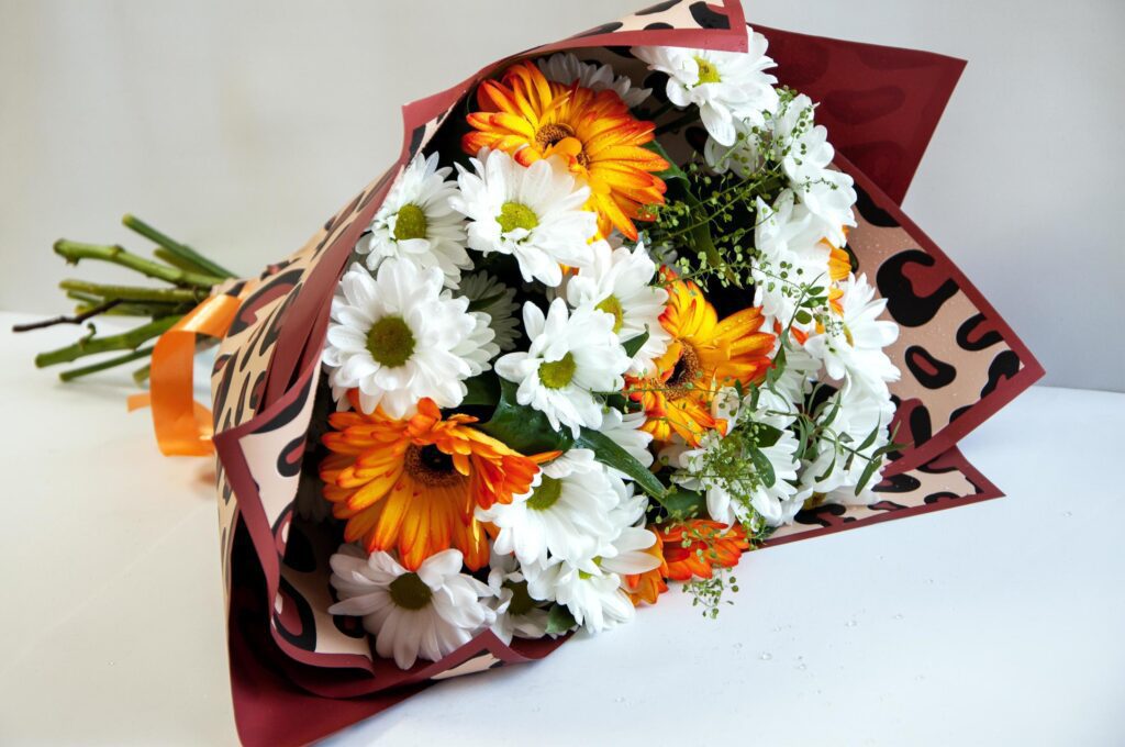 Photo of a bouquet of orange and white flowers on a white background Stock Free