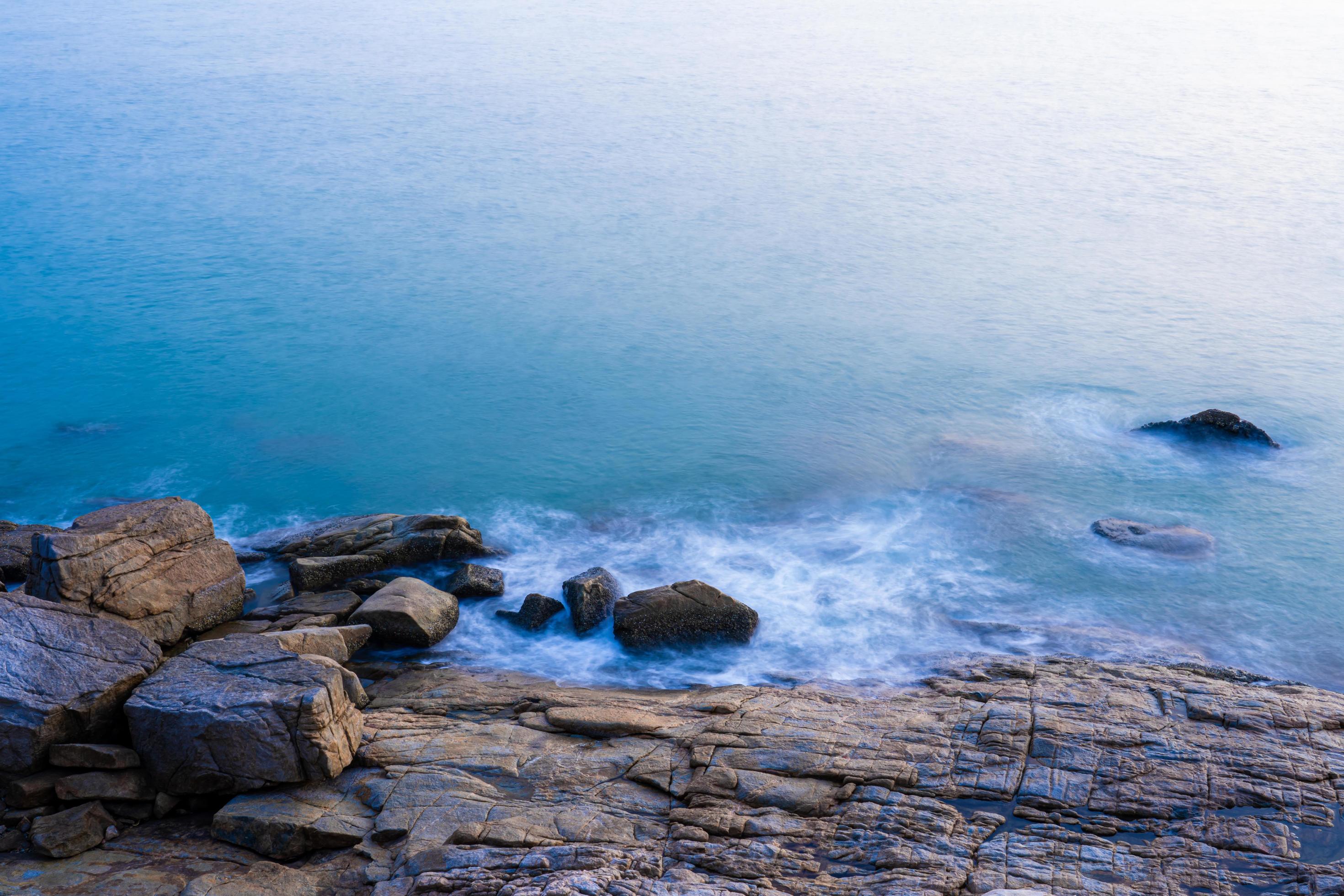 Nature view for soft wave and stone in the sea in morning for background and texture Stock Free