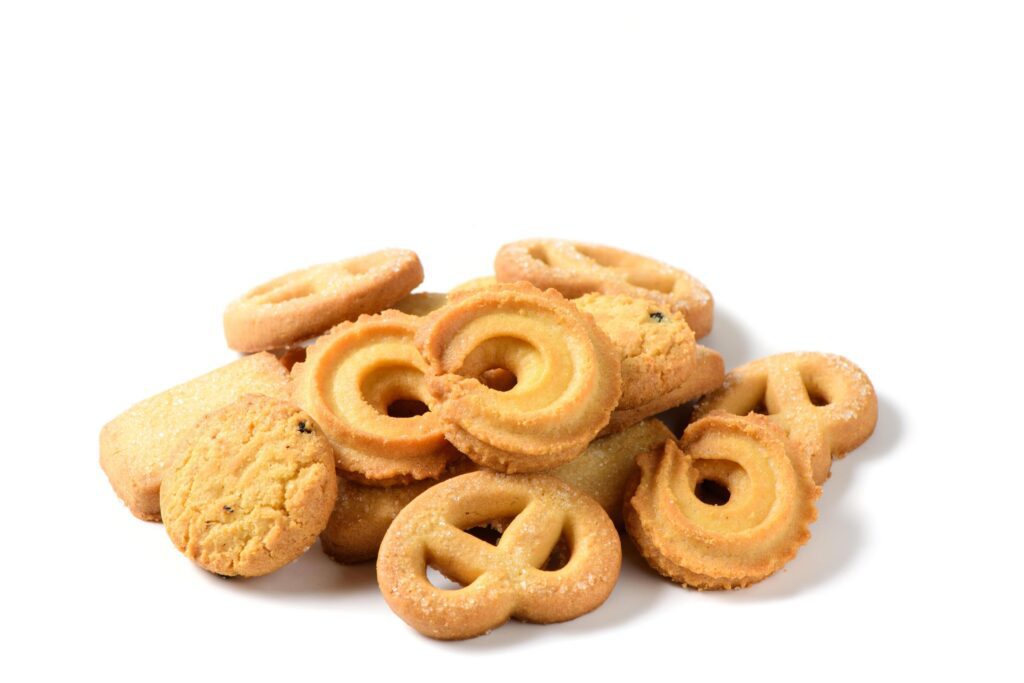 Set of danish butter cookies macro cutout. Five whole pretzel, round and rectangular shortbread biscuits with sugar on white background Stock Free