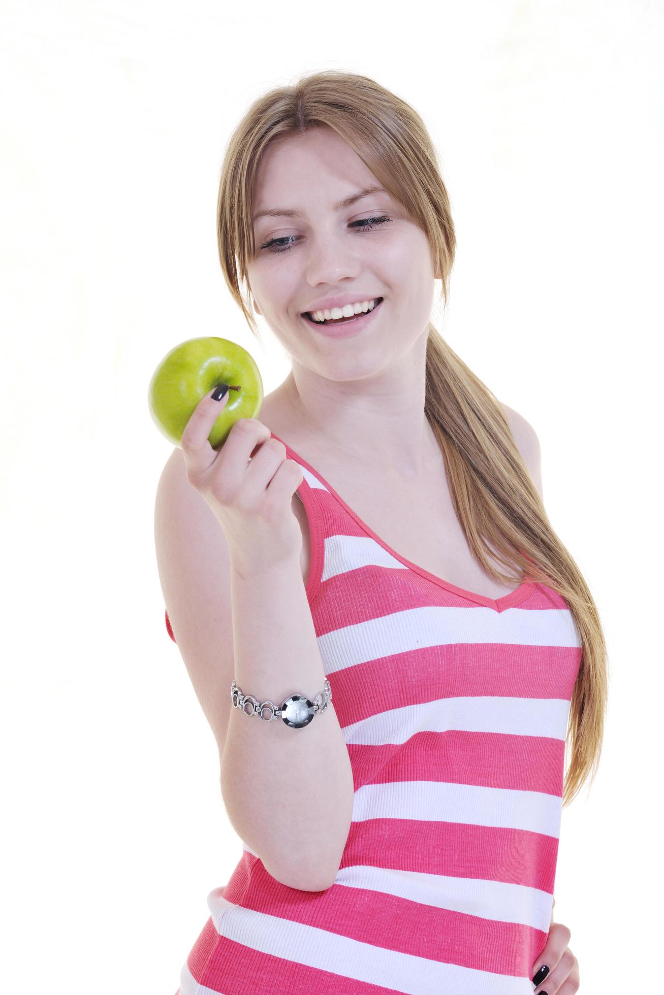 happy young woman eat green apple isolated on white Stock Free