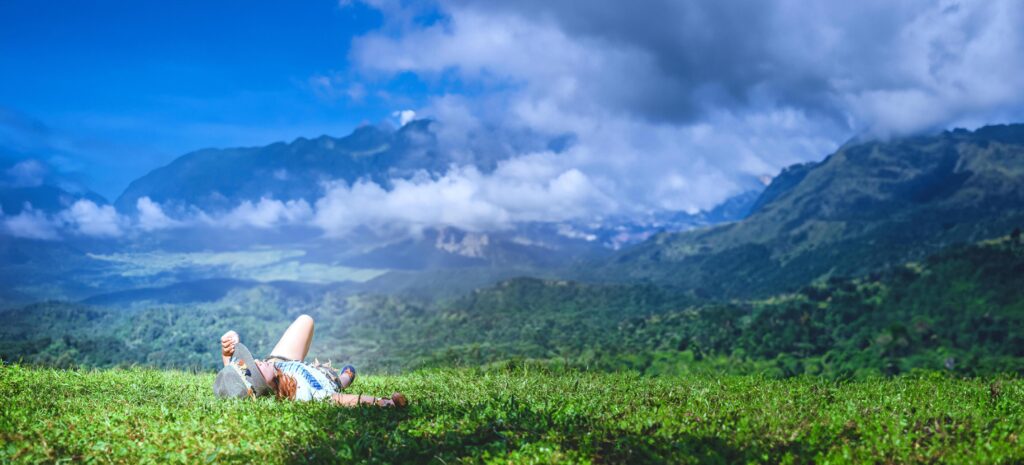 Asian woman travel relax in the holiday. Sleep relax on the lawn on the mountain. In Thailand Stock Free