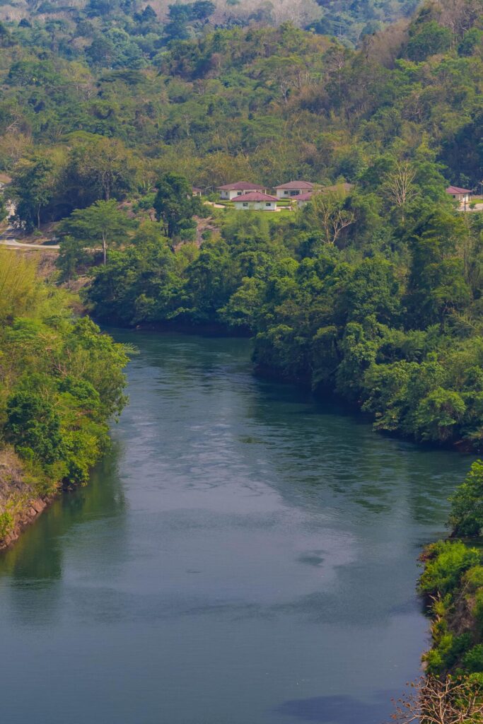 An aerial view of the dam-caused canal in Thailand’s national park, with a mountain the background. Bird eye view. Stock Free