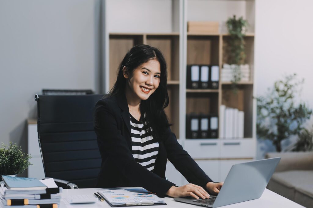 Young pretty business woman with notebook in the office Stock Free