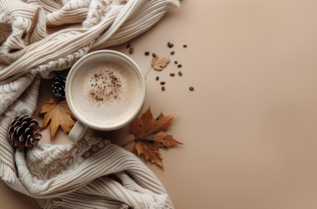 Warm Autumn Drink With Knit Blanket and Fall Leaves on Tan Background Stock Free