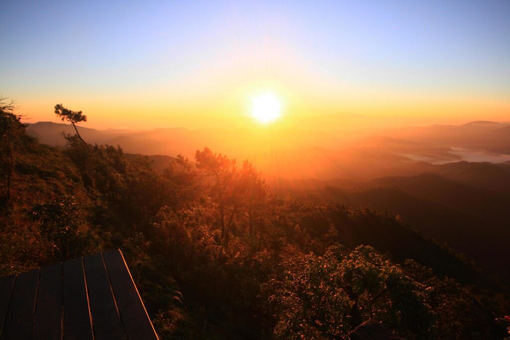 Beautiful golden natural sunlight and twiligh of sunrise shining to in the mist on valley of mountain in Thailand Stock Free