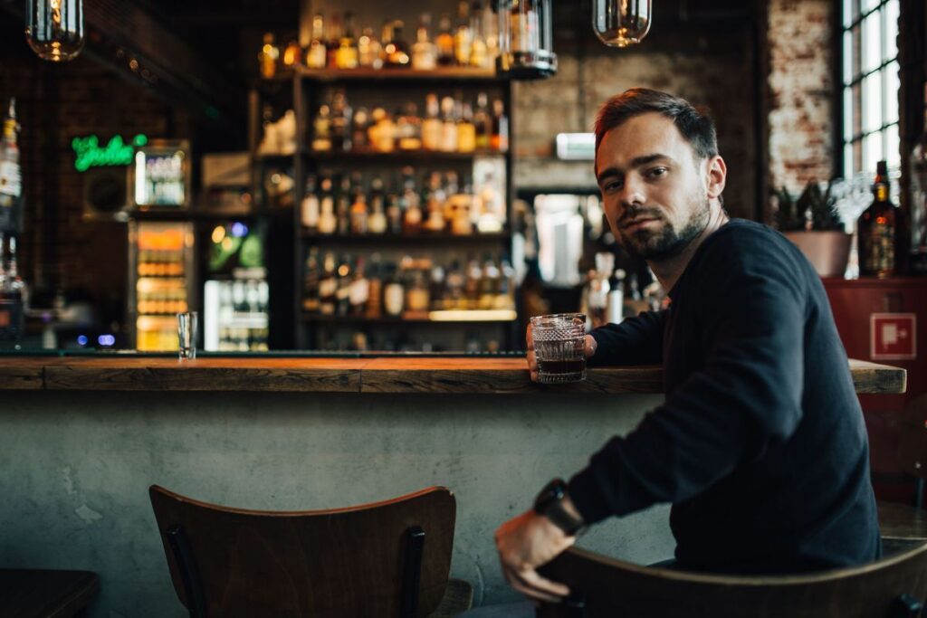 Handsome young man in a pub Stock Free